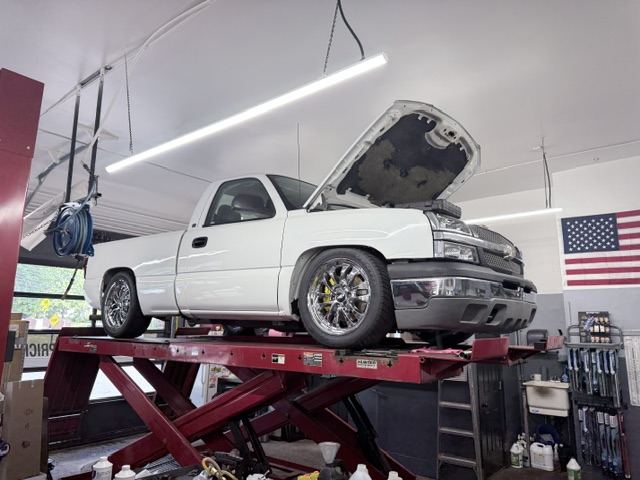 Pickup truck being serviced on a lift
